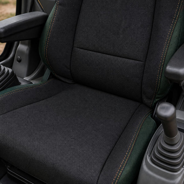 Bear Shield seat cover concept on a representative excavator seat, construction detail (AI-generated depiction)