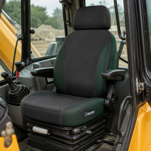 Bear Shield seat cover concept on a representative backhoe seat, installed in cab (AI-generated depiction)