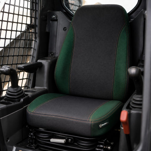 Bear Shield seat cover concept on a representative skid steer seat, installed in cab (AI-generated depiction)